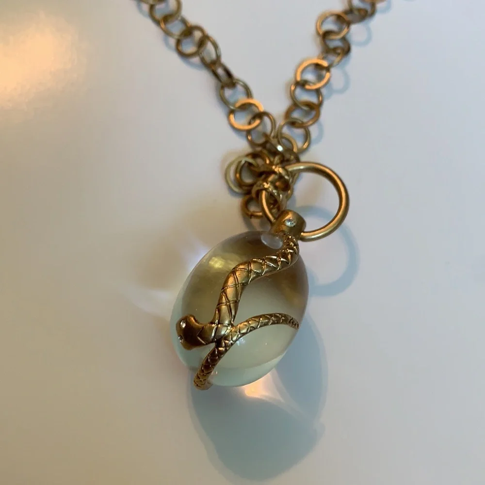 Vintage golden Snake wrapped around an elongated oval crystal